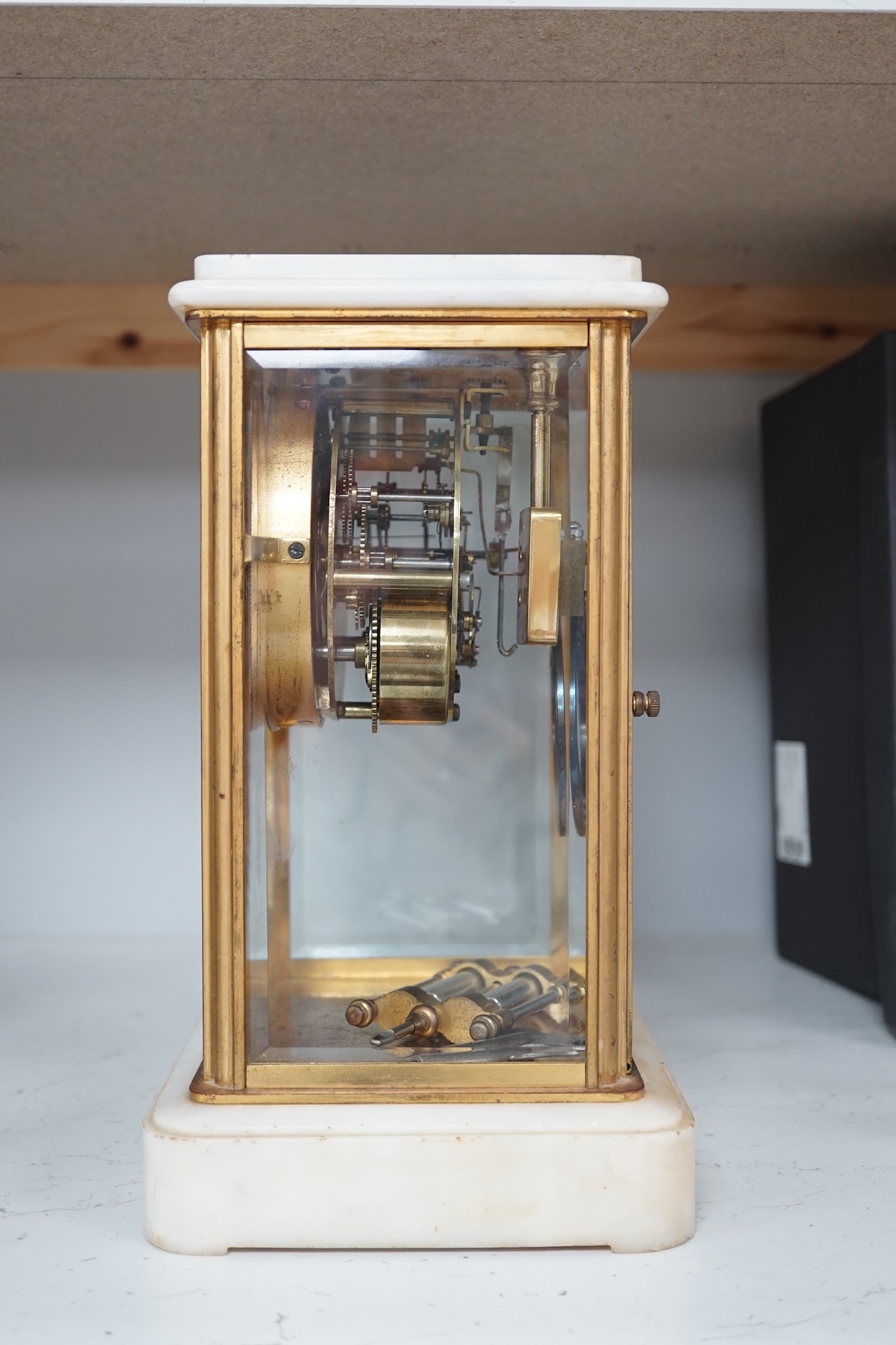 A Japanese four glass brass and alabaster mantel clock by Seikosha, with brocot type escapement and outside rack strike, striking on a coiled gong, height 27.5cm. Condition - fair to good.